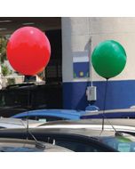 Adjustable Holiday Reusable Balloon Window Kits in red and green on a vehicle an auto dealership lot